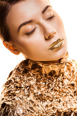 Wall Mural - young beautiful woman with closed eyes and golden lips in golden foil isolated on white