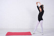 © mihakonceptcorn - A little girl in a gymnastic swimsuit performing exercises, free space.