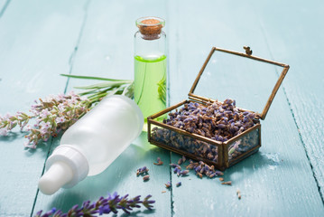 Poster - cream, shampoo, perfume product samples with lavender on old blue wood table background