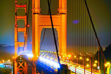 Canvas Print - View of Golden Gate Bridge with lots of cars passing through in San Francisco at night.