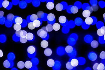 Wall Mural - Closeup blue abstract blurred and bokeh of LED party light bubs reflection lighting at night time.