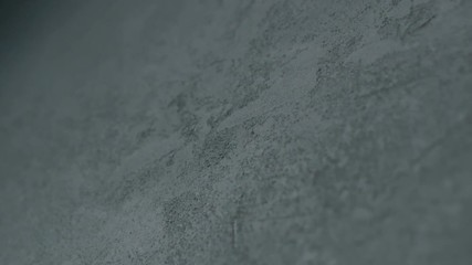 Sticker - Slow motion shot of decorative dark concrete surface, shot handheld