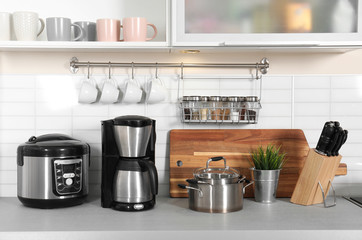 Poster - Different appliances, clean dishes and utensils on kitchen counter