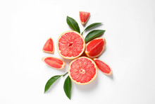 Grapefruits And Leaves On White Background, Top View. Citrus Fruits