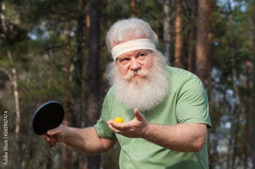 senior sportive man with passion to win going to serve a ball outdoor lifestyle portrait ping pong active sports buy this stock photo and explore similar images at adobe stock adobe stock
