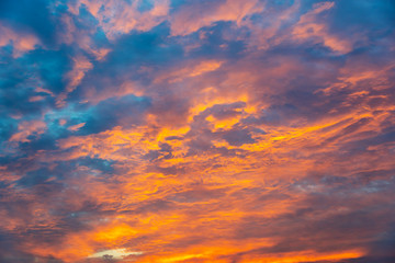 Wall Mural - dramatic orange sky with clouds at sunset
