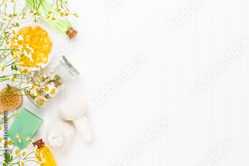 Spa still life with aromatherapy chamomile, herbal oil, soap, sea salt.