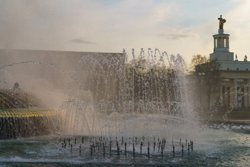 Wall Mural - Beautiful refreshing fountain Kamenny Tsvetok / Stone Flower on the Exhibition of Achievements of National Economy (VDNKh) in windy sunset. 