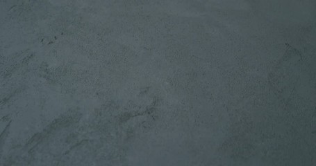 Sticker - Slow motion shot of decorative dark concrete surface, shot handheld