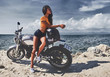 sexy asian woman near her vintage custom motorcycle