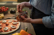 © eskstock - Fresh pizza with tomato and mushrooms. Homemade tasty pizza on dark wooden background. Raw dough for pizza with ingredients and spices on wooden rustic table. Traditional Italian food. Soft focus.