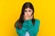Teenager girl over yellow wall with surprise facial expression