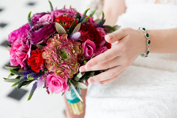 Wall Mural - Exquisite bouquet of red and pink roses and peonies in the hands of the bride