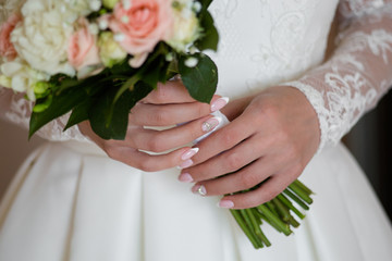 Wall Mural - Wedding bouquet of pink roses and white freesias in the hands of the bride