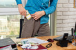 Office worker puts a wad of money in his pocket