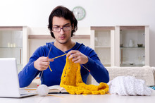 Young Good Looking Man Knitting At Home