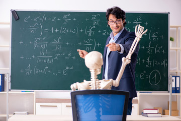 Young male math teacher and student skeleton 