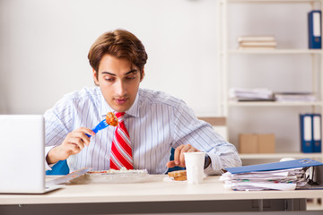 Wall Mural - Man having meal at work during break