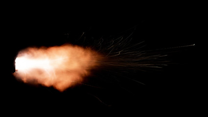 Wall Mural - Texture of firearm shot with bright flash of light, sparks, smoke and gunpowder gases on black background