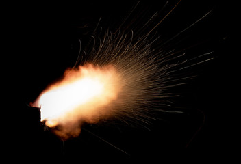 Wall Mural - Texture of firearm shot with bright flash of light, sparks, smoke and gunpowder gases on black background