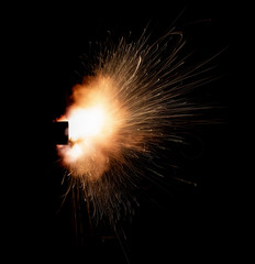 Wall Mural - Texture of firearm shot with bright flash of light, sparks, smoke and gunpowder gases on black background