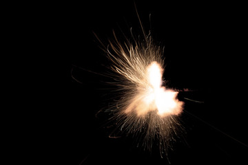 Wall Mural - Texture of firearm shot with bright flash of light, sparks, smoke and gunpowder gases on black background