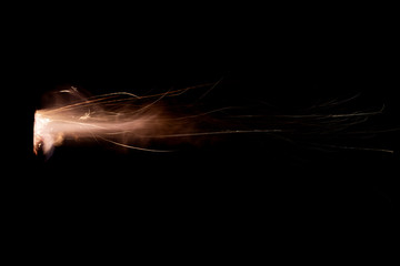 Wall Mural - Texture of firearm shot with bright flash of light, sparks, smoke and gunpowder gases on black background