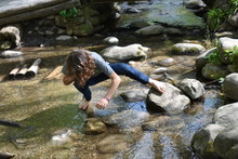 Barefoot Boy Exploring Stream Or Creek