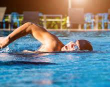 Young Athletic Man Swimming In The Swimming Pool