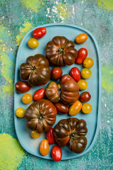 Wall Mural - Colorful tomato variety on wooden board