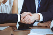 © rogerphoto - Business people shaking hands at meeting or negotiation in the office. Handshake concept. Partners are satisfied because signing contract