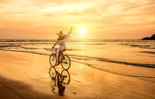 Happiness Woman Traveler With Her Bicycle Rides On Sea Coastline
