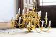 Chandelier lights antique gold on floor salvage removed from ceiling in construction site
