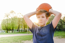 Young Boy Playing A Game Of Basketball