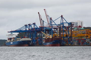 Vladivostok Commercial Sea Port. Container terminal in the port. Industrial marine facade of Vladivostok.