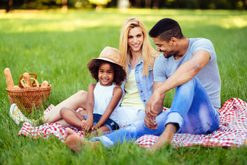 Picture of lovely couple with their daughter having picnic