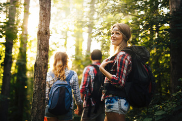 Wall Mural - people trekking in forest and having fun
