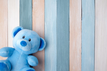 Teddy Bear toy alone on pastel wooden background