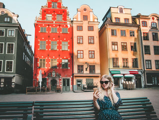 woman tourist in stockholm city gamla stan traveling lifestyle girl using smartphone blogging europe