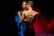 © the faces - attractive girl holding her sexy lover in embrace, isolated black background.close up photo