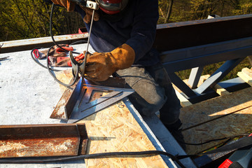 Worker welding in a factory. Welding on an industrial plant.