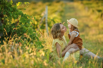 A Happy family walking history. mother and baby hugging in a meadow yellow flowers on nature in summer