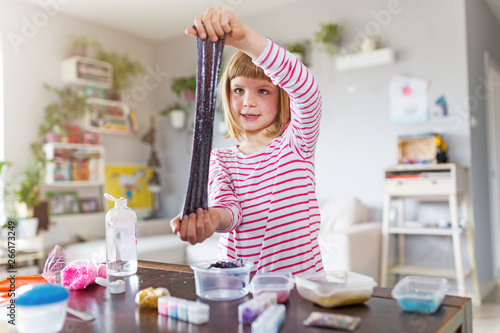 Cuadros en Lienzo Little girl making homemade slime toy