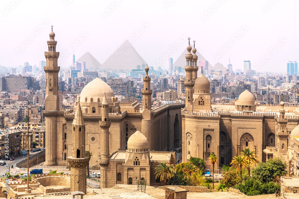 The Mosque-Madrassa of Sultan Hassan and the Pyramids in the background, Cairo, Egypt - obrazy, fototapety, plakaty 