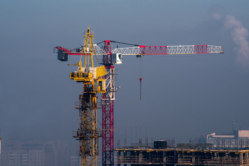 Two cranes on winter construction site