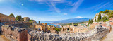 Fototapeta  - Panoramic view of ruins of Ancient Greek theatre in Taormina on background of Etna Volcano, Italy.
