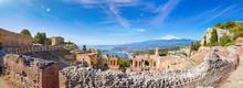 Panoramic View Of Ruins Of Ancient Greek Theatre In Taormina On Background Of Etna Volcano, Italy.