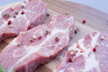 Pork neck steak. Fresh pork with spices. Close-up.