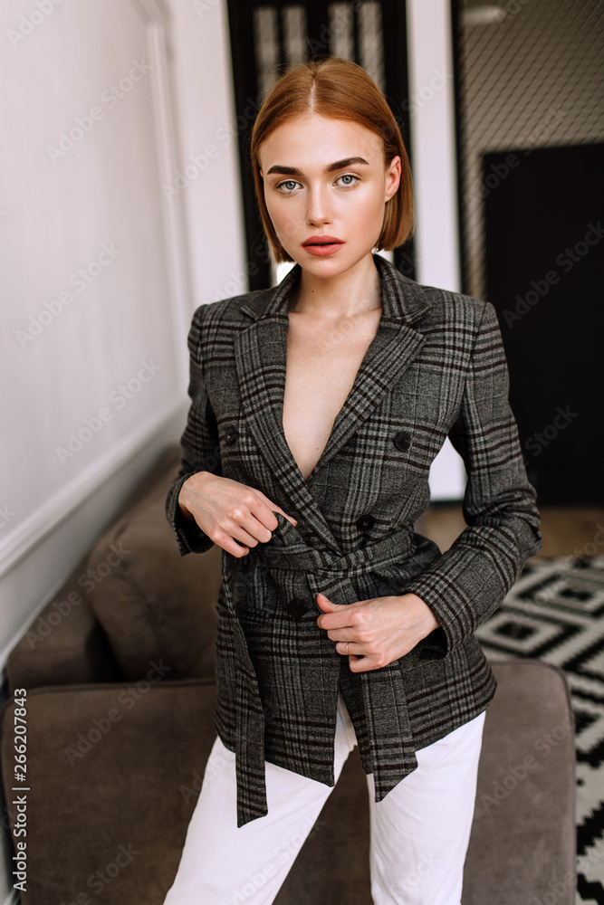 A beautiful sweet girl, dressed on a naked body jacket. Golden stylish