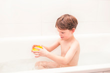 Happy 5 Year Old Boty Playing In A Bathtub